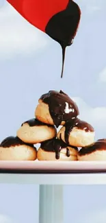 Profiteroles with chocolate sauce against a sky background.