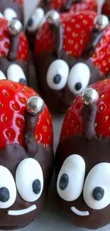 Cute chocolate-covered strawberry characters with eyes and red tops.