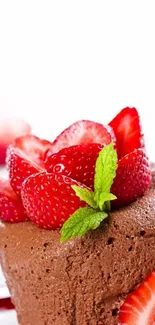 Chocolate mousse with strawberries and mint leaves on top.