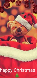 Teddy bear in Santa hat inside red sack with Christmas decorations.