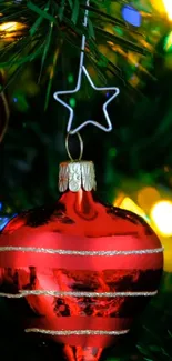 Red Christmas ornament with green branches and colorful lights.