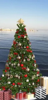 Festive Christmas tree on a beach with wrapped gifts beneath.