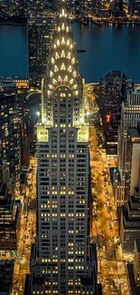 Night view of the Chrysler Building in NYC, beautifully lit against a dark blue sky.