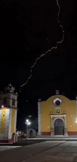 Dramatic lightning bolt over church at night.