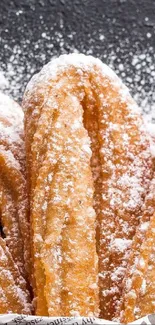 Golden churros sprinkled with powdered sugar.