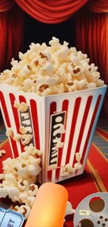 Popcorn box with theater backdrop, tickets, and film reel.