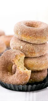 Stack of cinnamon sugar donuts on a light background.