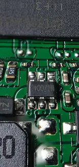 Close-up of a detailed circuit board with green pathways and components.