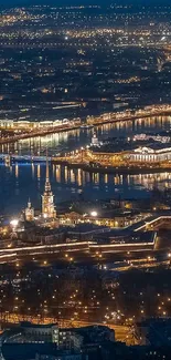 Aerial view of a city with twinkling lights at night, showcasing urban beauty.