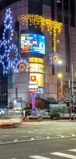 Vibrant city street at night with colorful lights and festive decorations.