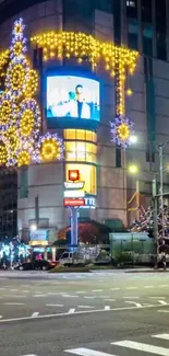 City lit up with Christmas decorations at night.