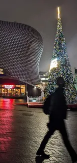 Night cityscape with Christmas tree and silhouette.