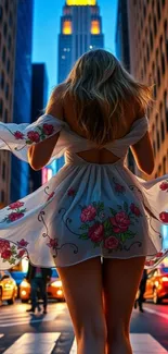Woman in floral dress walking in vibrant city at night.
