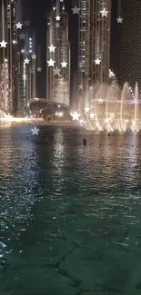 Night cityscape with fountains and stars reflecting on the water.