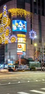 Festive city night with bright holiday lights illuminating the urban street.