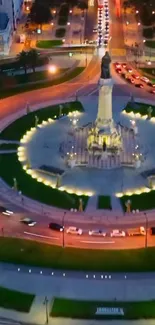 Nighttime city monument with vibrant lights.