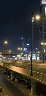 Nighttime cityscape with bright urban lights and towering skyscrapers.