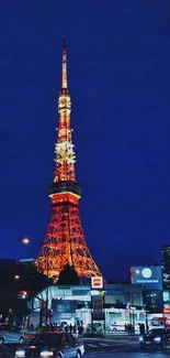 Brightly lit tower in a city night scene.