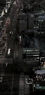 Aerial view of city traffic at night with vibrant lights and bustling streets.