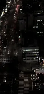 Aerial view of city streets at night showcasing traffic and lights.