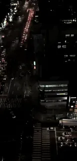 Nighttime view of a busy city street with vibrant lights and bustling traffic.