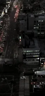 Nighttime aerial view of a bustling city street with lights.