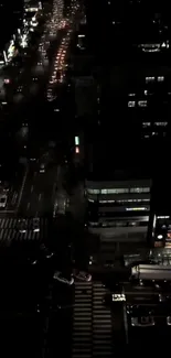 Nighttime cityscape with bright streetlights and busy roads.