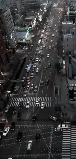 Aerial view of bustling city streets at night with vibrant traffic and lights.