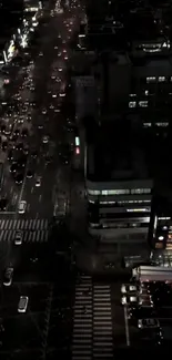 Aerial night view of bustling city streets.