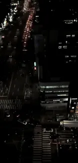 A vibrant city nightscape with illuminated streets seen from above.