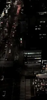 A vibrant city street view at night with illuminated buildings.