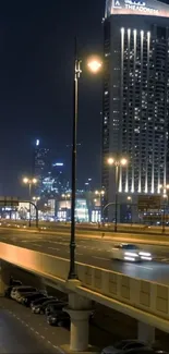 City nightscape with illuminated buildings and street lights.