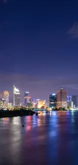 Stunning city view at night with reflections on water.