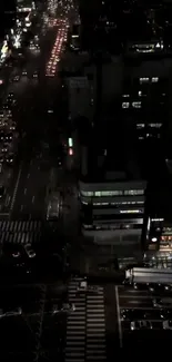 Aerial view of urban city street lit up at night.