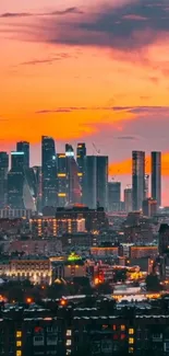 City skyline with vibrant sunset over skyscrapers.