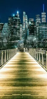 Illuminated boardwalk leading to a city skyline at night.