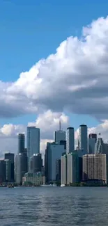 Mobile wallpaper of a city skyline with a blue sky backdrop.