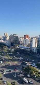 City skyline under clear blue sky with traffic, buildings, and bustling life.