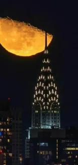 Illuminated city skyline with a large golden moon in the night sky.