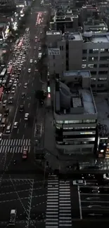 A city street at dusk with busy traffic and illuminated buildings.