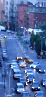 Blurry city street view with blue tint, cars, and buildings in the background.