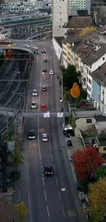 Aerial view of a city street with evening traffic and buildings.