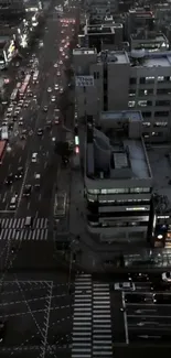 Aerial view of city streets illuminated at night.