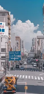 Urban city street wallpaper with blue sky and vibrant buildings.