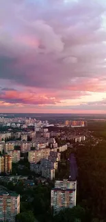 Cityscape under a dreamy pink sunset sky with urban skyline.