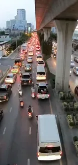 Busy evening city traffic under skytrain.