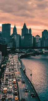 Urban skyline at sunset with river and warm sky hues.