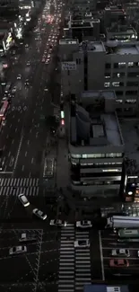 Aerial view of city streets at night with traffic and lights