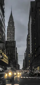 City skyline at dusk with illuminated streetlights and skyscrapers.