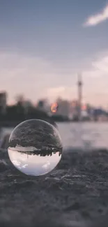 Cityscape reflected in a glass sphere with a soft purple hue.